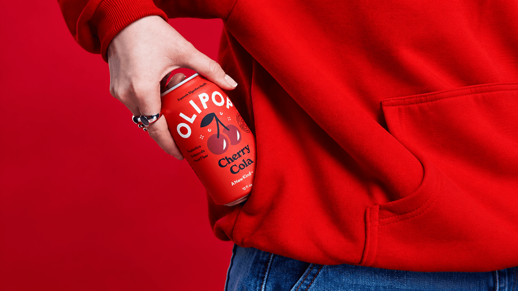 A vivid red product campaign image for a cherry cola brand.