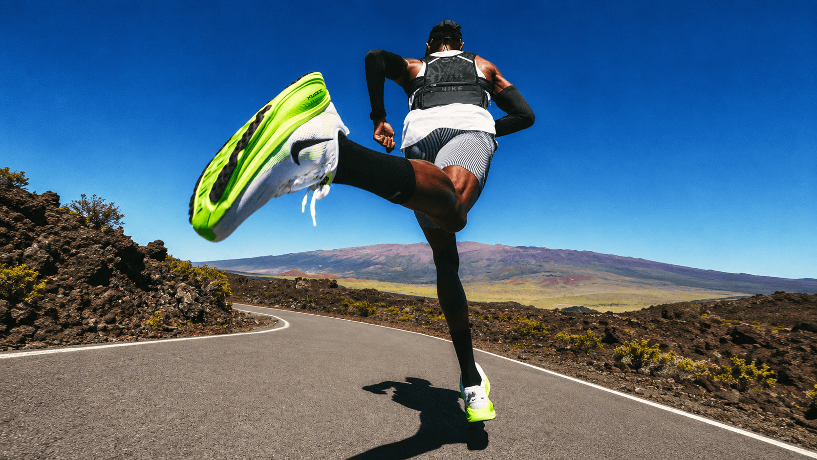 A runner moving through a wide open landscape.